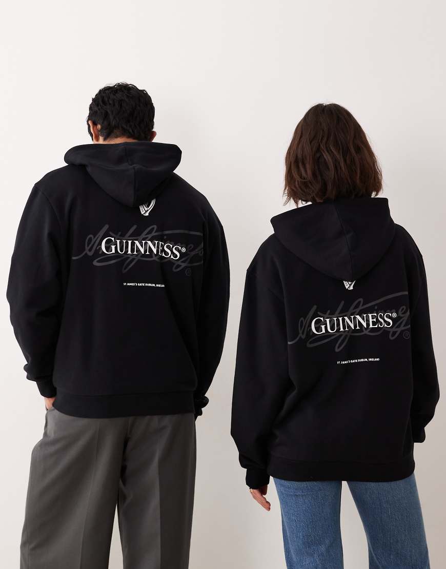 ASOS DESIGN - Unisex-Kapuzenpullover in Schwarz mit lizenzierten „Guinness"-Prints und Relaxed-Fit-Design von ASOS DESIGN