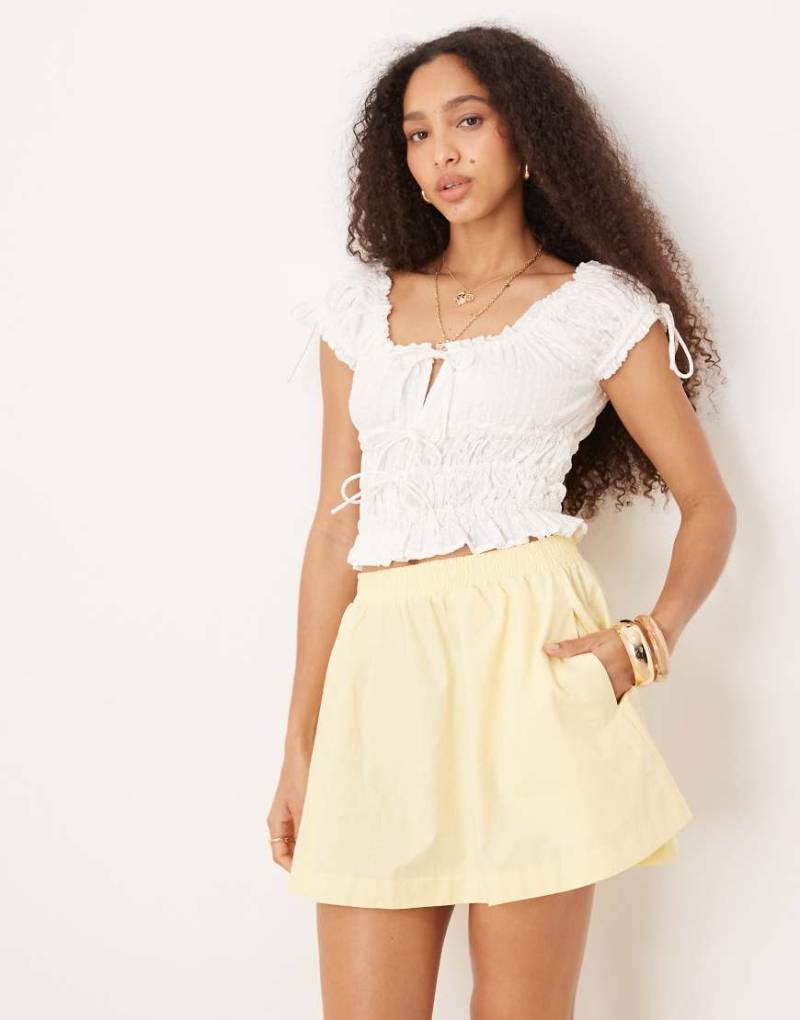 ASOS DESIGN - Voluminöser Minirock in Buttermilchgelb mit abgerundetem Saum von ASOS DESIGN