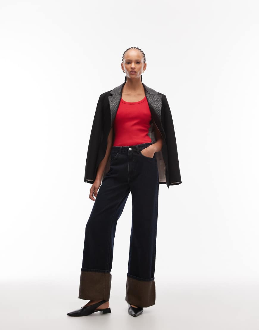 ASOS DESIGN - Weit geschnittene Jeans in Indigoblau mit brauner Tönung und sehr breitem Umschlag von ASOS DESIGN