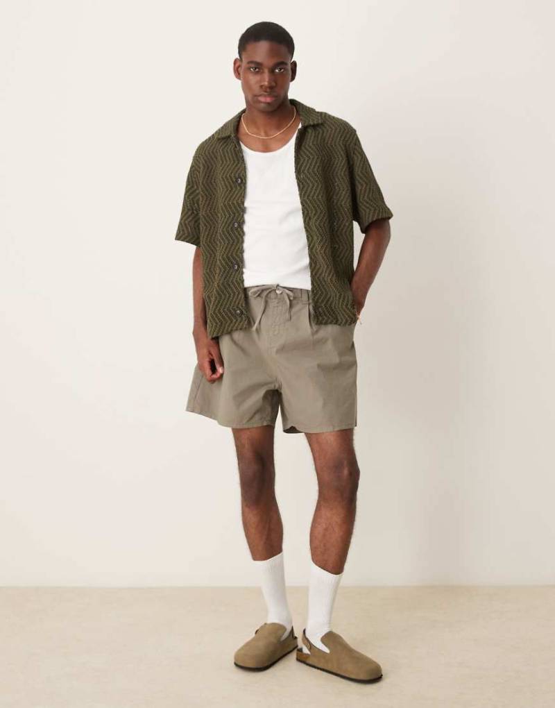 ASOS DESIGN - Weite, kürzer geschnittene Shorts in Khaki mit Bundfalten und Kordelzugbund-Grün von ASOS DESIGN