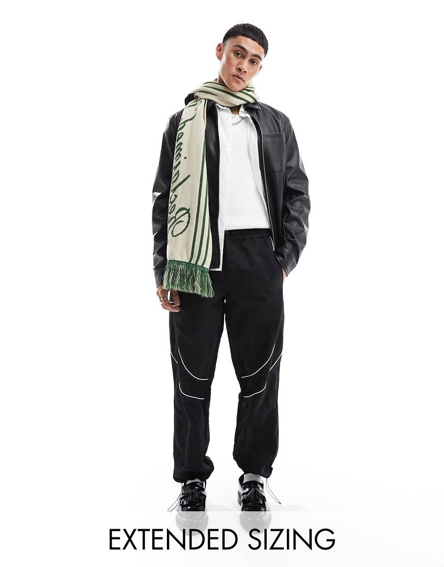 ASOS DESIGN - Weite Nylon-Trainingshose in Schwarz mit farblich abgesetzter Paspelierung von ASOS DESIGN