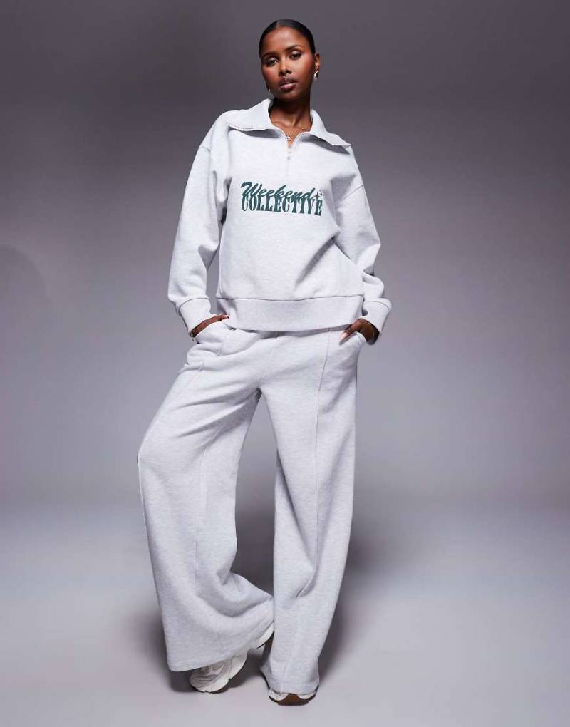 Weekend Collective - Sweatshirt in grau meliert mit kurzem Reißverschluss und Schriftzug in verschiedenen Schriftarten von ASOS Weekend Collective