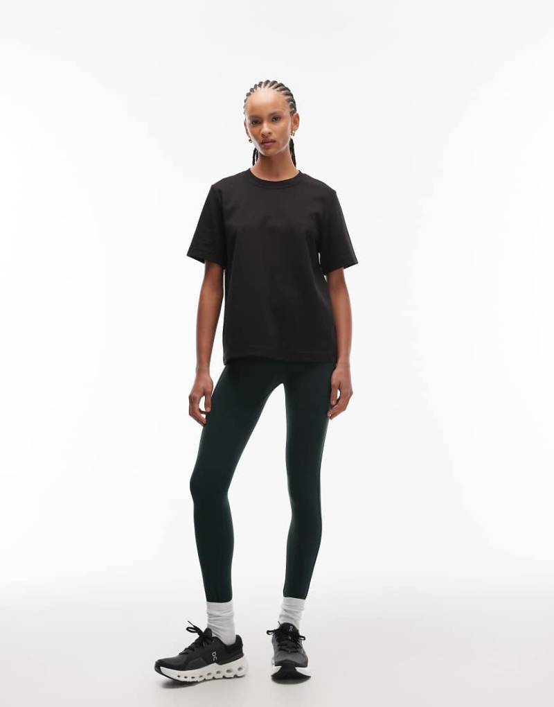 ARKET - Nahtlose Sport-Leggings in Dunkelgrün mit Seitentaschen von Arket