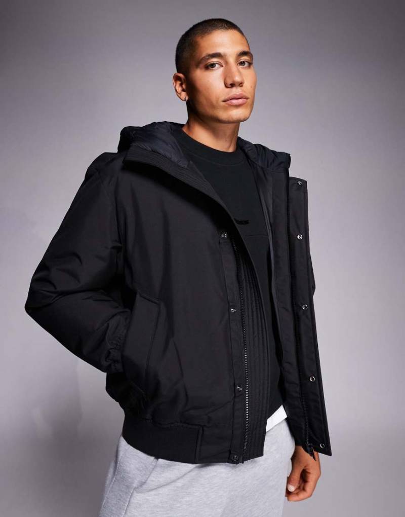 Boss Orange - Osis - Schwere, wattierte Bomberjacke in Schwarz mit Kapuze von BOSS Orange