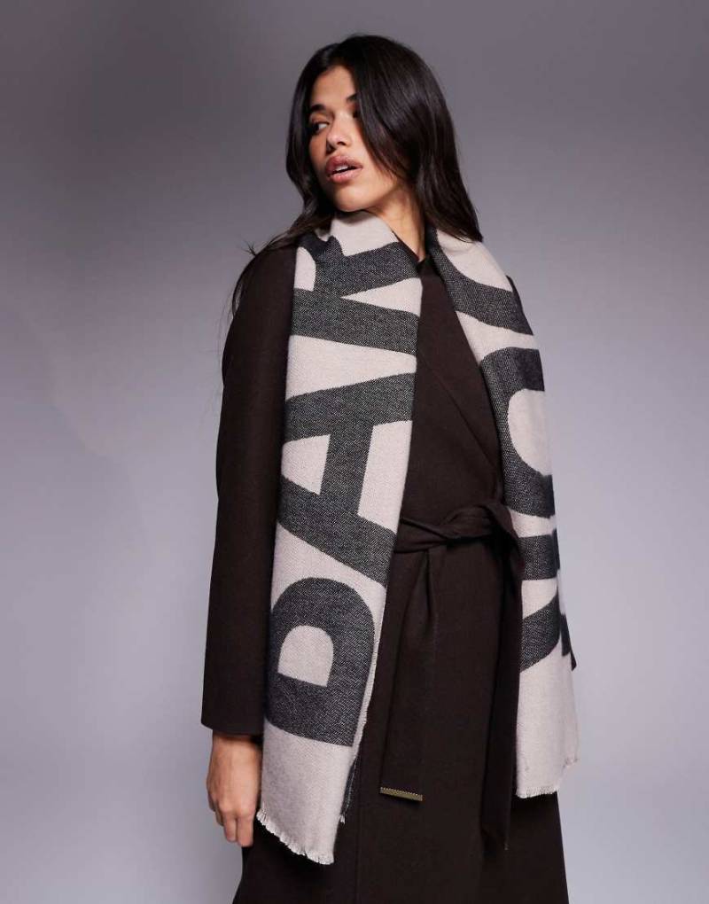 Barbour International - Milla - Schal in Hellbeige und Schwarz mit Logo Barbour International - Milla - Schal in Hellbeige und Schwarz mit Logo von Barbour International