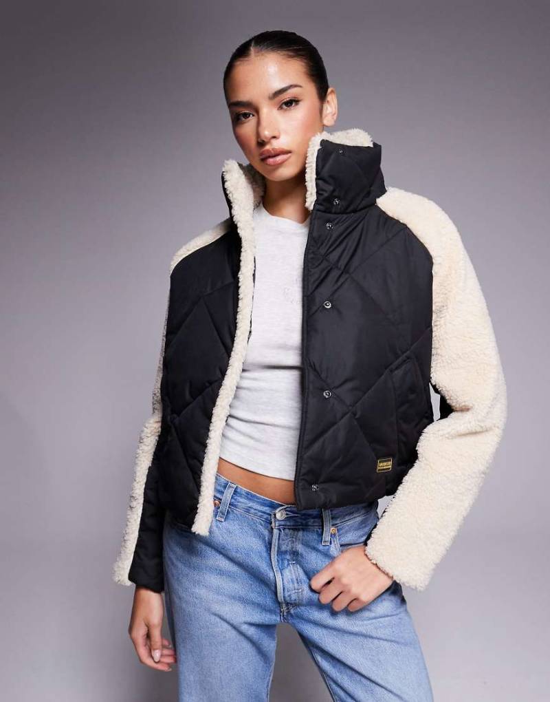 Barbour International - Oversize-Steppjacke in Schwarz und Beige mit Fleece-Ärmeln von Barbour International