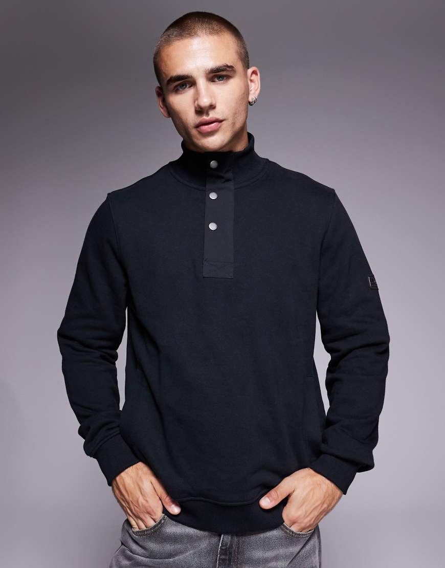 Barbour International - Sweatshirt in Schwarz mit halblangem Reißverschluss Barbour International - Sweatshirt in Schwarz mit halblangem Reißverschluss von Barbour International