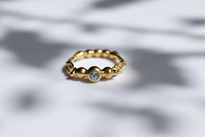 Goldring Mit Figuren An Der Seite von Bernsteinerie