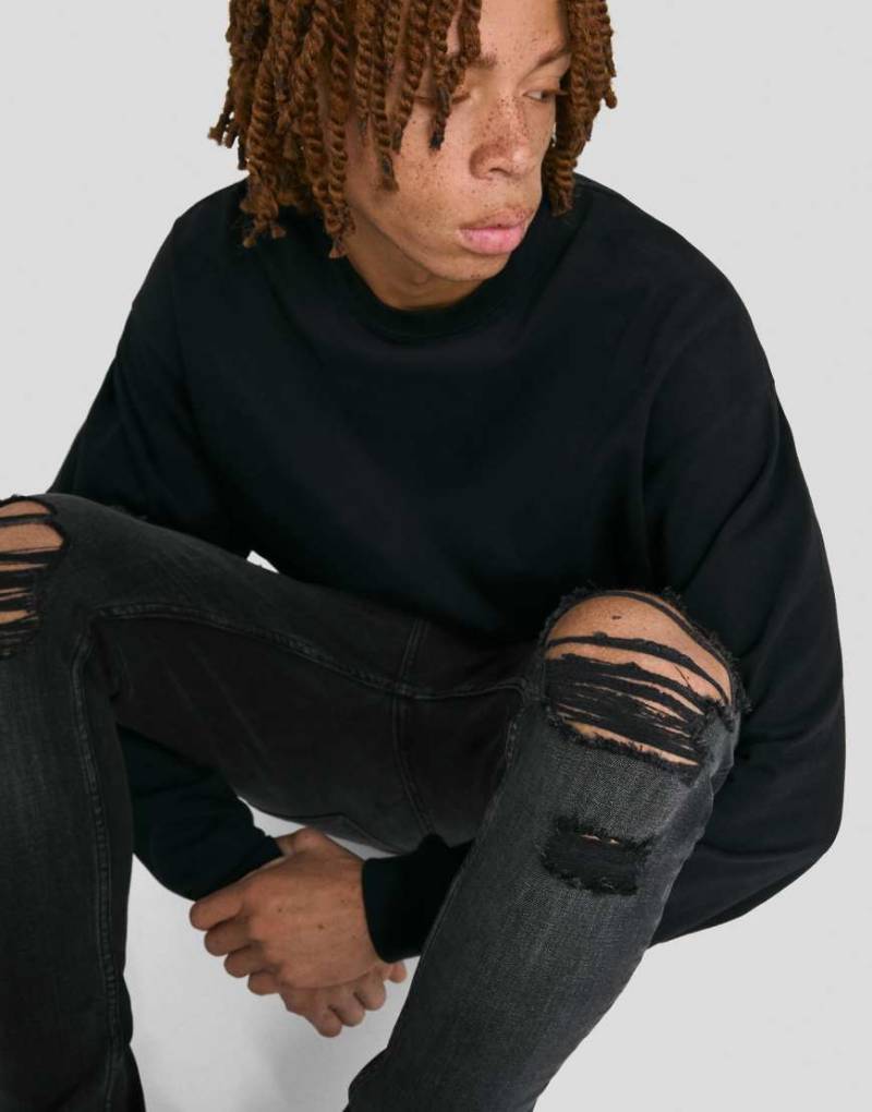 Bershka - Sehr enge Jeans in Schwarz mit Zierrissen von Bershka