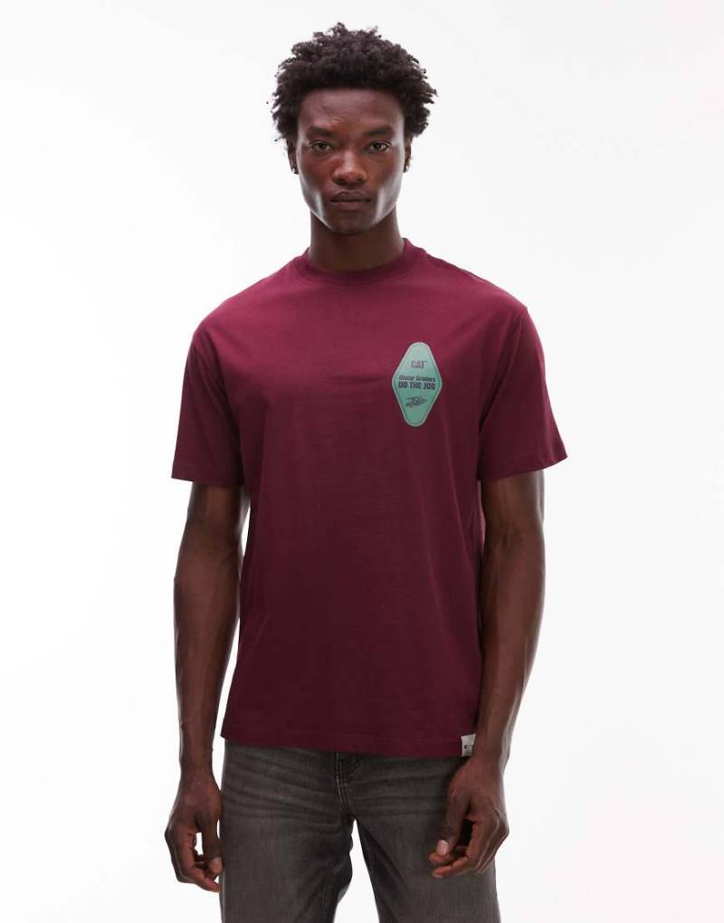 CAT - WWR - Loose-Fit-T-Shirt in Burgunderrot mit Logo-Grafik, 180 g/m² CAT - WWR - Loose-Fit-T-Shirt in Burgunderrot mit Logo-Grafik, 180 g/m² von CAT WWR
