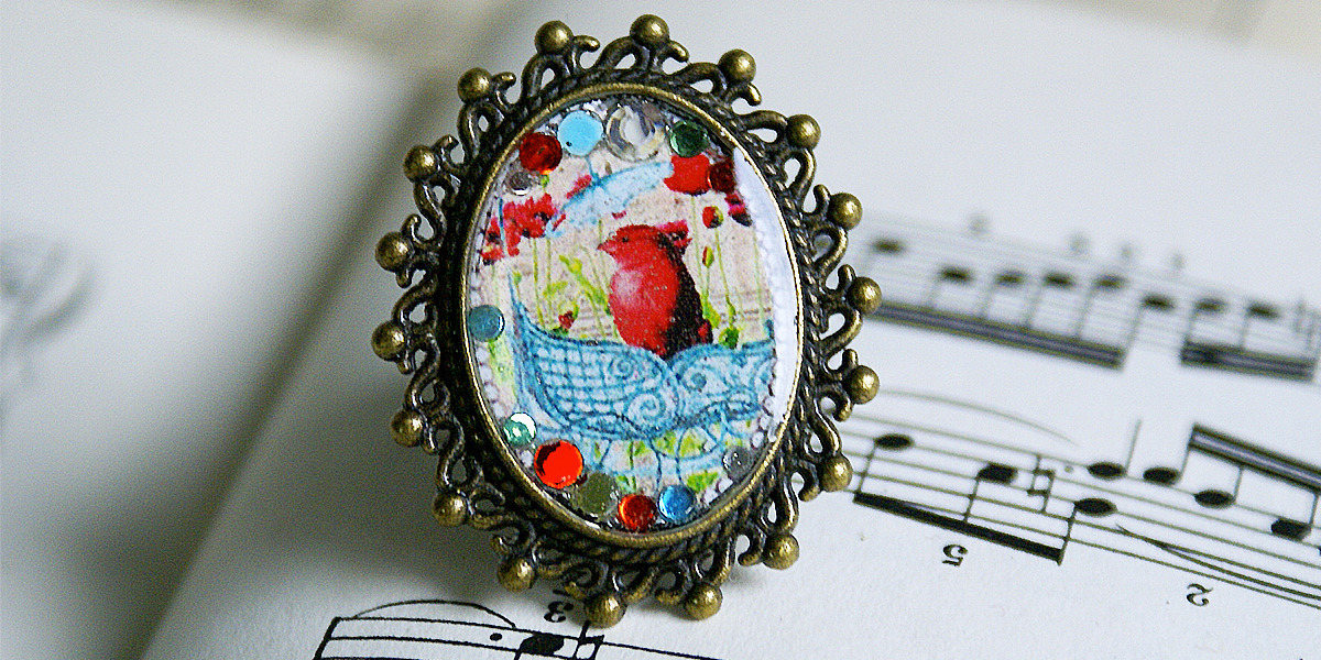 Bronzefarbener Metallring Und Harz, Der Einen Vogel in Seinem Nest Darstellt von COMME1ange