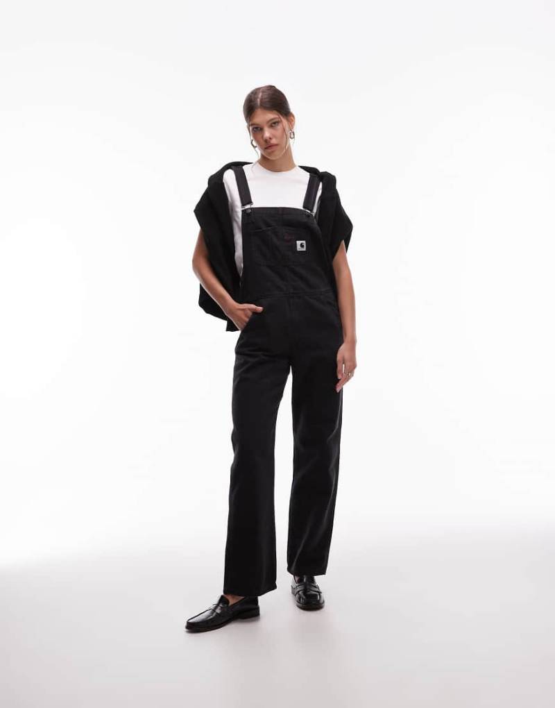 Carhartt WIP - Jeanslatzhose in verwaschenem Schwarz Carhartt WIP - Jeanslatzhose in verwaschenem Schwarz von Carhartt WIP