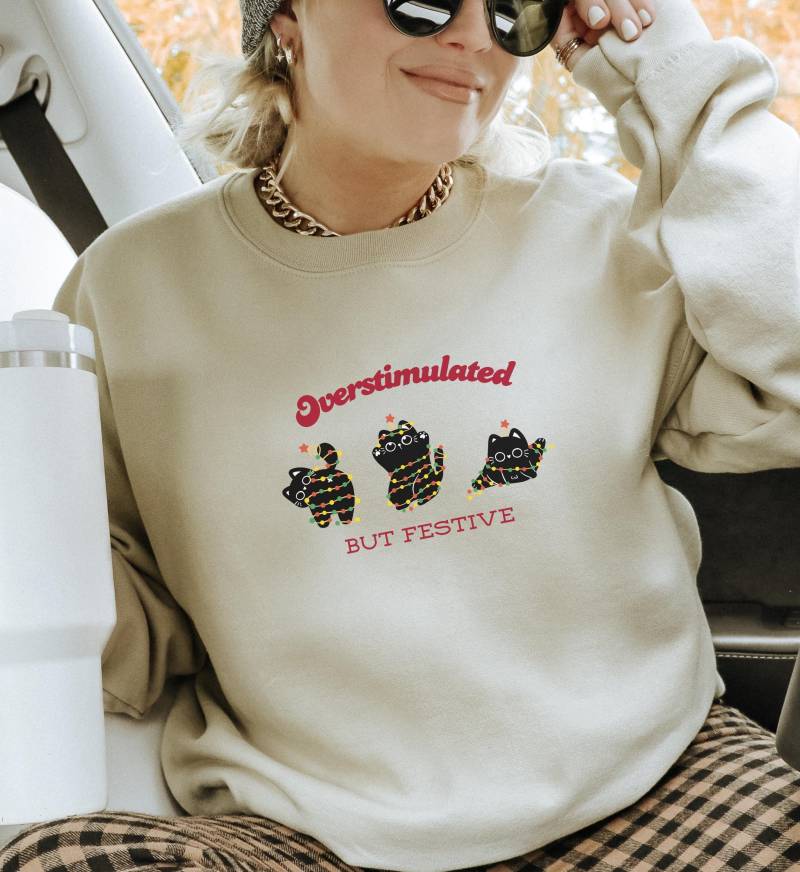 Funny Cat Christmas Sweatshirt Overstimulated But Festive Ugly Xmas Sweater Angry Lover Gift Holiday Party Outfit Unhinged Bestie von CincerelyYoursShop