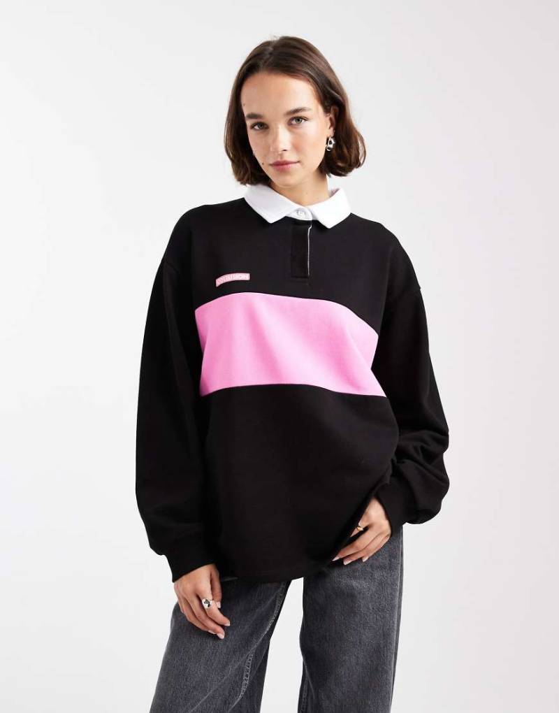 COLLUSION - Polo-Oberteil in Schwarz mit Colourblock-Design COLLUSION - Polo-Oberteil in Schwarz mit Colourblock-Design von Collusion