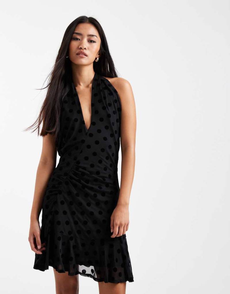 COLLUSION - Schwingendes Minikleid mit beflockten Polka Dots, überkreuztem Detail und Neckholder-Schwarz von Collusion