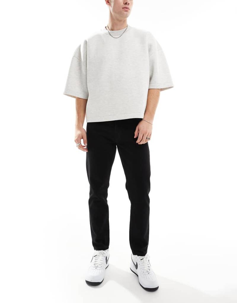 DTT - Feste, schmal zulaufende Jeans in Schwarz mit verkürztem Schnitt von Don't Think Twice