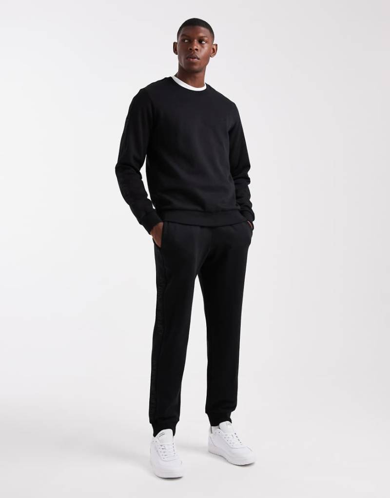 Emporio Armani - Lounge-Trainingsanzug in Schwarz mit Logo-Band Emporio Armani - Lounge-Trainingsanzug in Schwarz mit Logo-Band von Emporio Armani