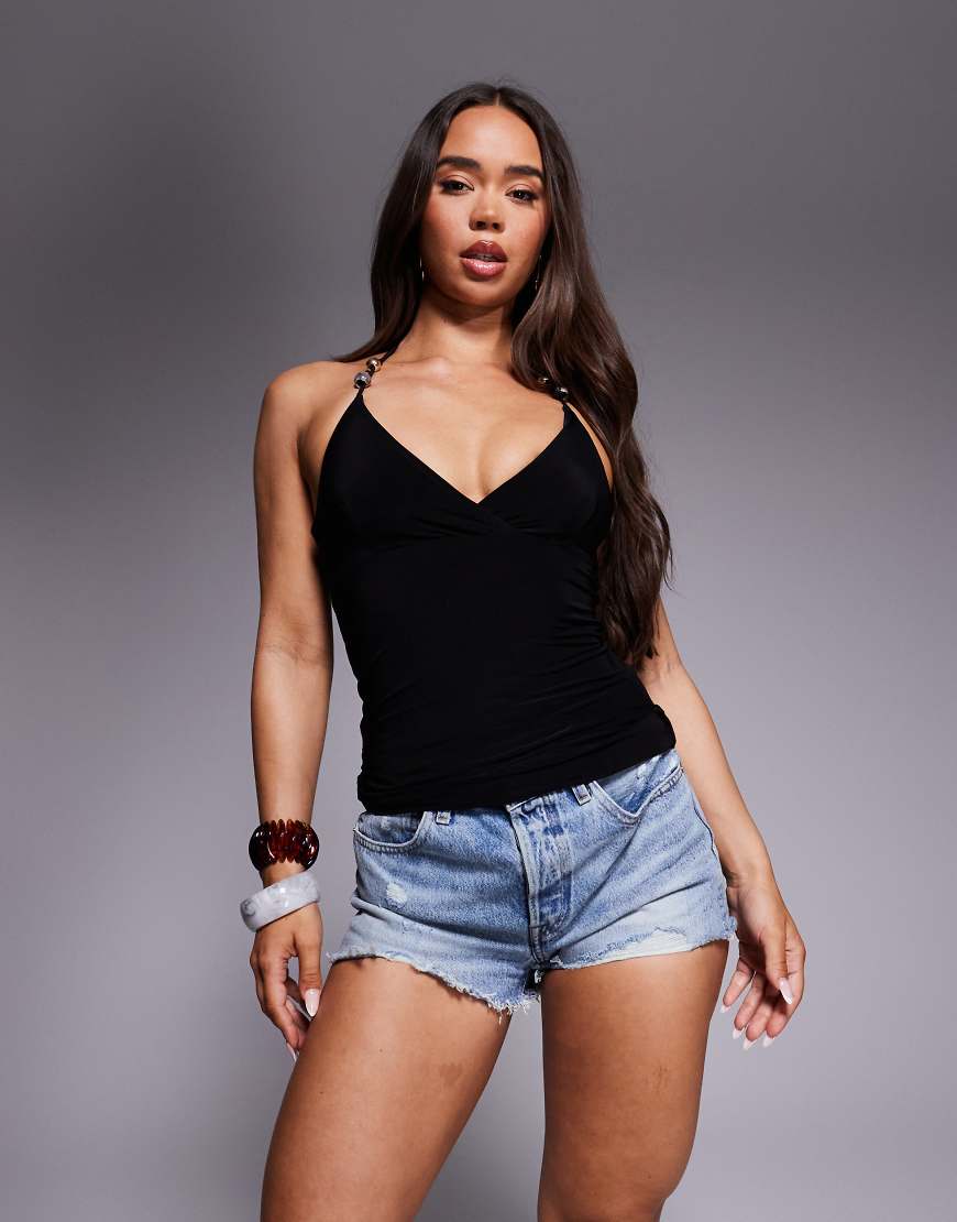 Fashionkilla - Exklusiv - Anschmiegsames, doppellagiges, figurbetontes Camisole in Schwarz mit Neckholder und Perlen-Detail Fashionkilla - Exklusiv - Anschmiegsames, doppellagiges, figurbetontes Camisole in Schwarz mit Neckholder und Perlen-Detail von Fashionkilla