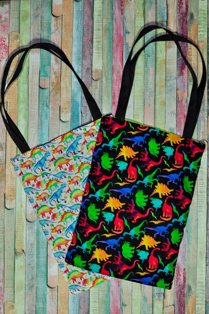 Nerditotes Regenbogen Dinosaurier Tote Bag Nerditotes Regenbogen Dinosaurier Tote Bag von FullMoonPhoenix