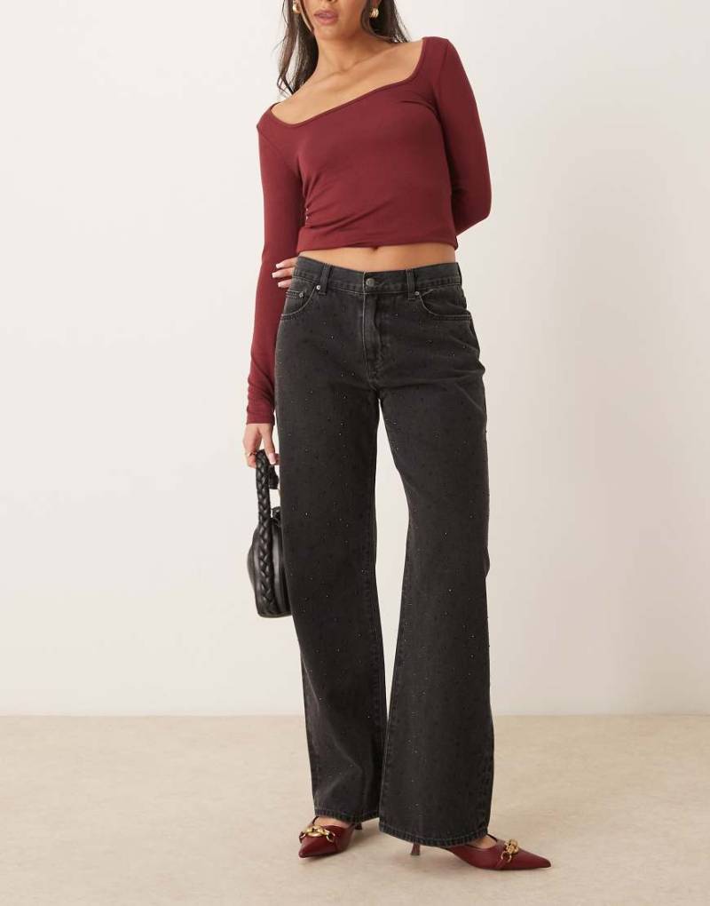 Gina Tricot - Jeans in gewaschenem Schwarz mit Kristallverzierung, weitem Bein und niedrigem Bund Gina Tricot - Jeans in gewaschenem Schwarz mit Kristallverzierung, weitem Bein und niedrigem Bund von GINA TRICOT