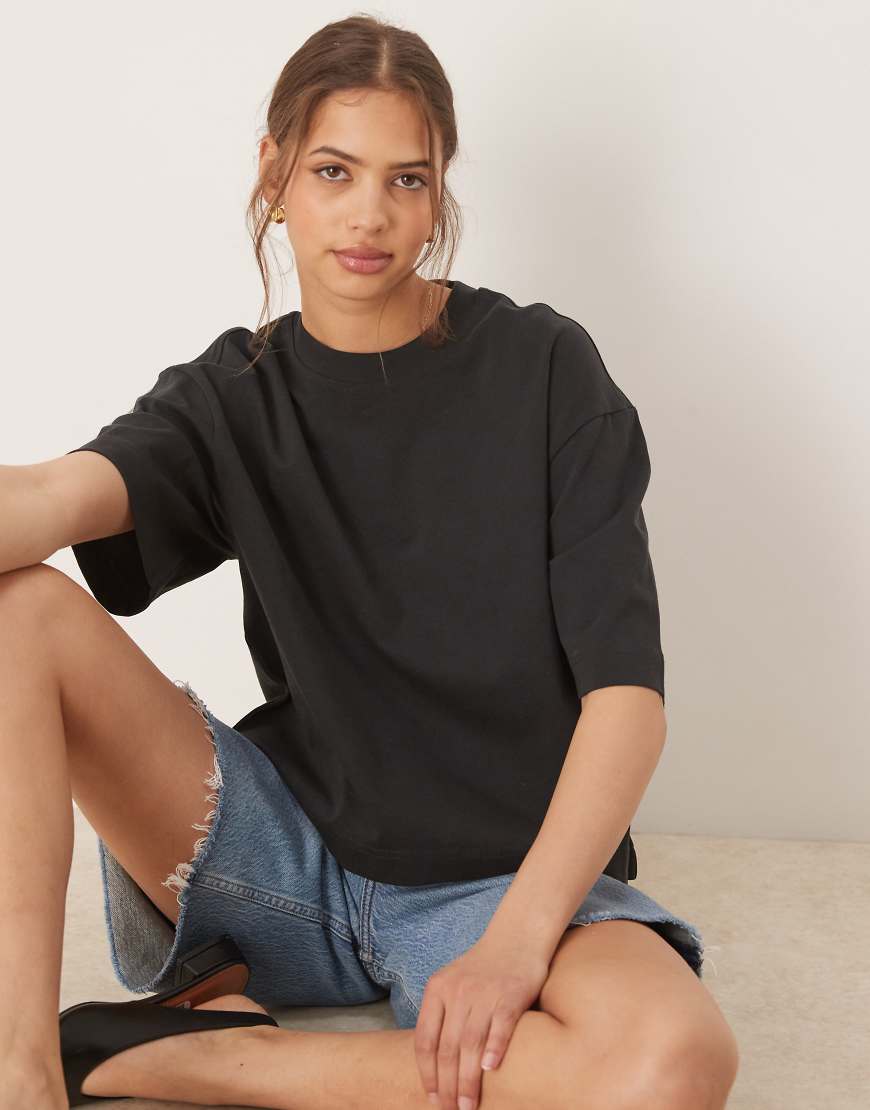 Gina Tricot - Kastiges, kurzärmliges T-Shirt in Schwarz Gina Tricot - Kastiges, kurzärmliges T-Shirt in Schwarz von GINA TRICOT
