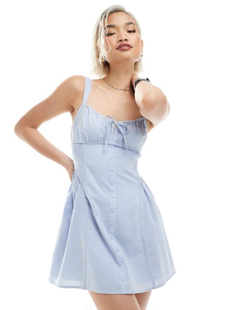 Hollister - Ärmelloses Mini-Milchmädchenkleid in Staubblau mit Knopfleiste und tiefer Taille Hollister - Ärmelloses Mini-Milchmädchenkleid in Staubblau mit Knopfleiste und tiefer Taille von Hollister