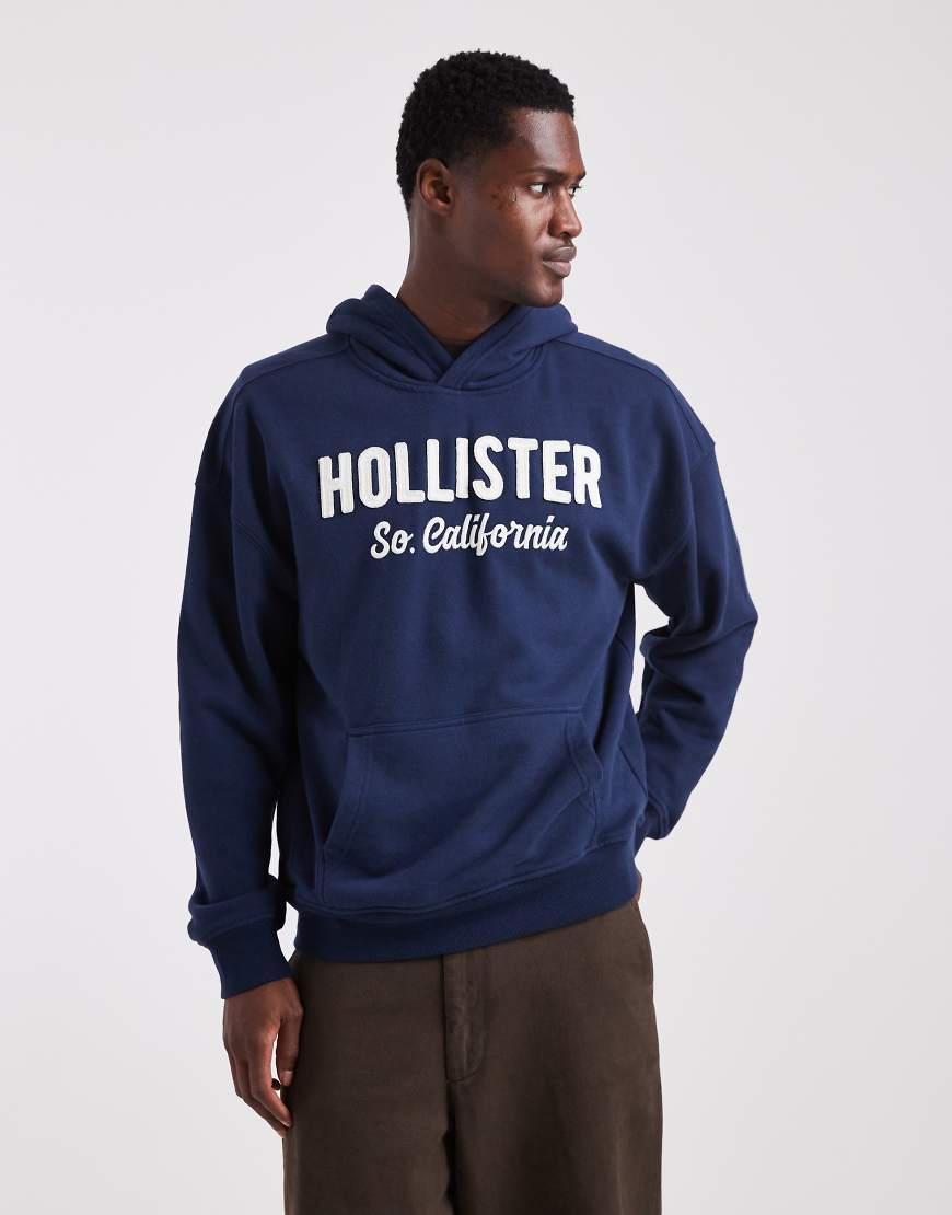 Hollister - Kastiger Frottee-Kapuzenpullover in Marineblau mit Logo von Hollister