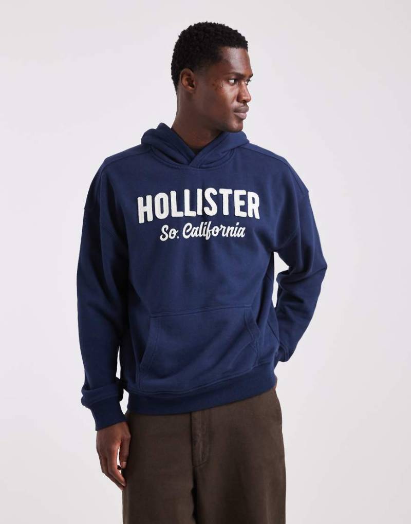 Hollister - Kastiger Frottee-Kapuzenpullover in Marineblau mit Logo von Hollister