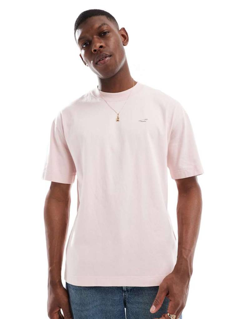 Hollister - Kastiges T-Shirt in verwaschenem Hellrosa mit Markenlogo Hollister - Kastiges T-Shirt in verwaschenem Hellrosa mit Markenlogo von Hollister