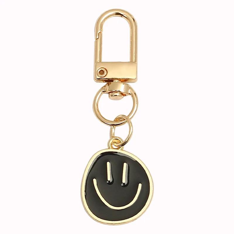 Lieblicher Smiley-Gesicht Schlüsselanhänger Niedlich Weiß Lila Gelb Rosa Blau Schwarz Emaille Metall Schlüsselring Taschenanhänger Zubehör Frauen Mädchen schwarz von Joom DACH