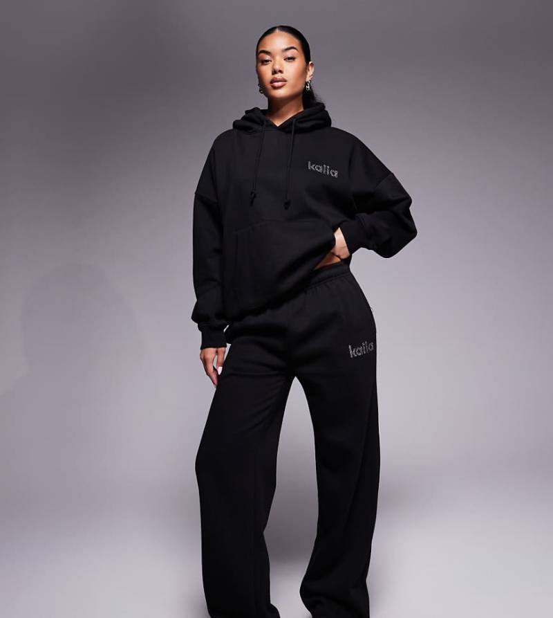 Kaiia - Exclusive - Jogginghose mit hohem Baumwollanteil in Schwarz, weitem Bein und strassbesetztem Logo, Kombiteil von Kaiia