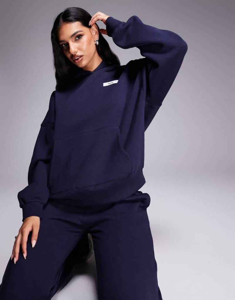 Kaiia - Oversize-Kapuzenpullover mit hohem Baumwollanteil in Marineblau mit Logo-Aufnäher, Kombiteil von Kaiia