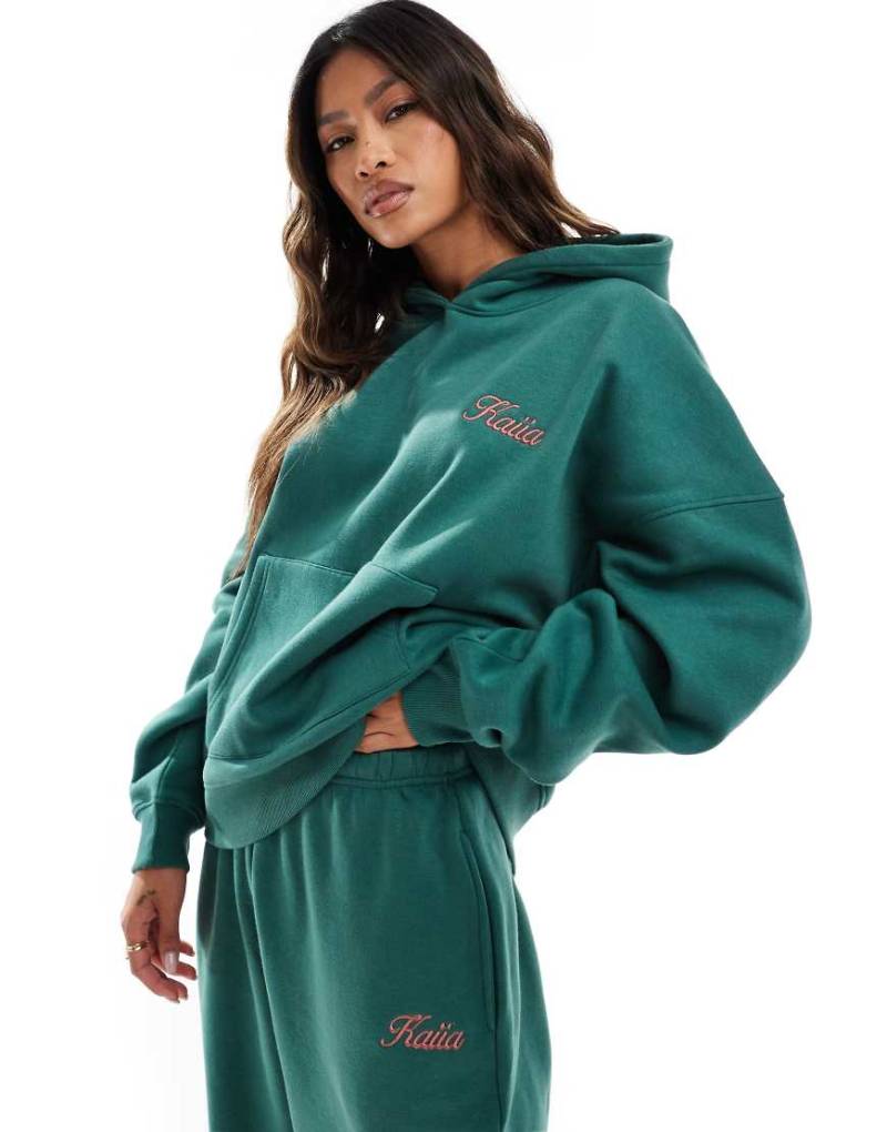 Kaiia - Oversize-Kapuzenpullover in Dunkelgrün mit rosa Logo, Kombiteil von Kaiia