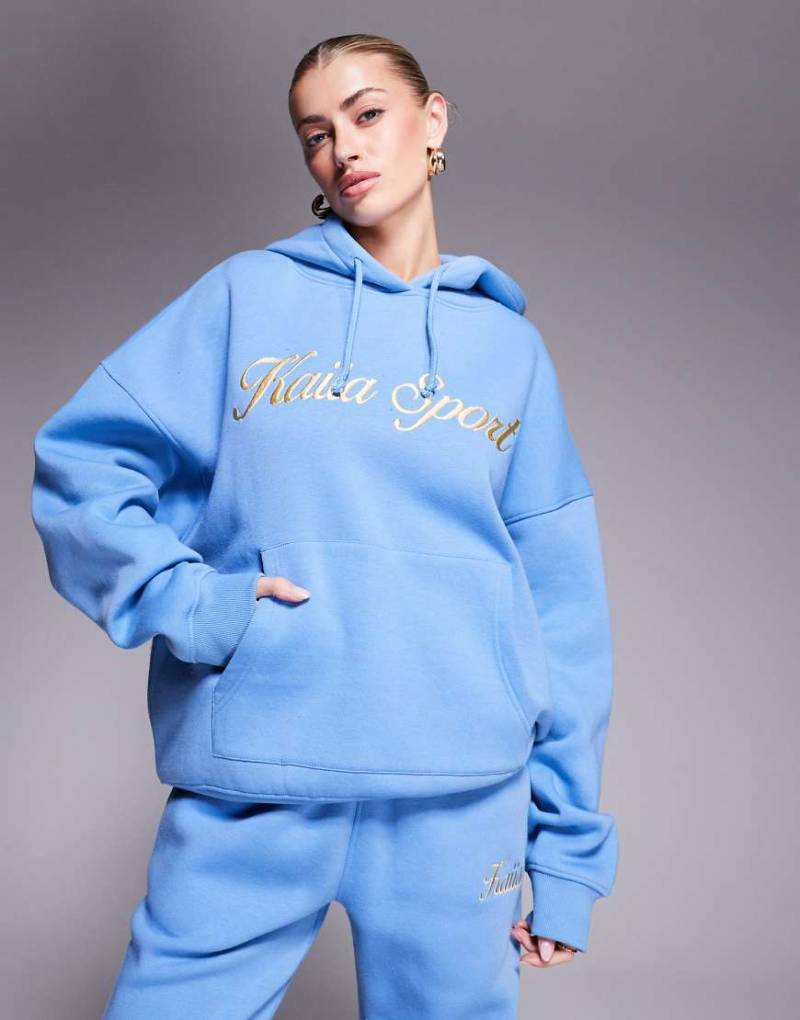 Kaiia - Sport - Kapuzenpullover aus Baumwollmix in Blau mit aufgesticktem Schriftzug-Logo in Gelb, Kombiteil-Bunt von Kaiia