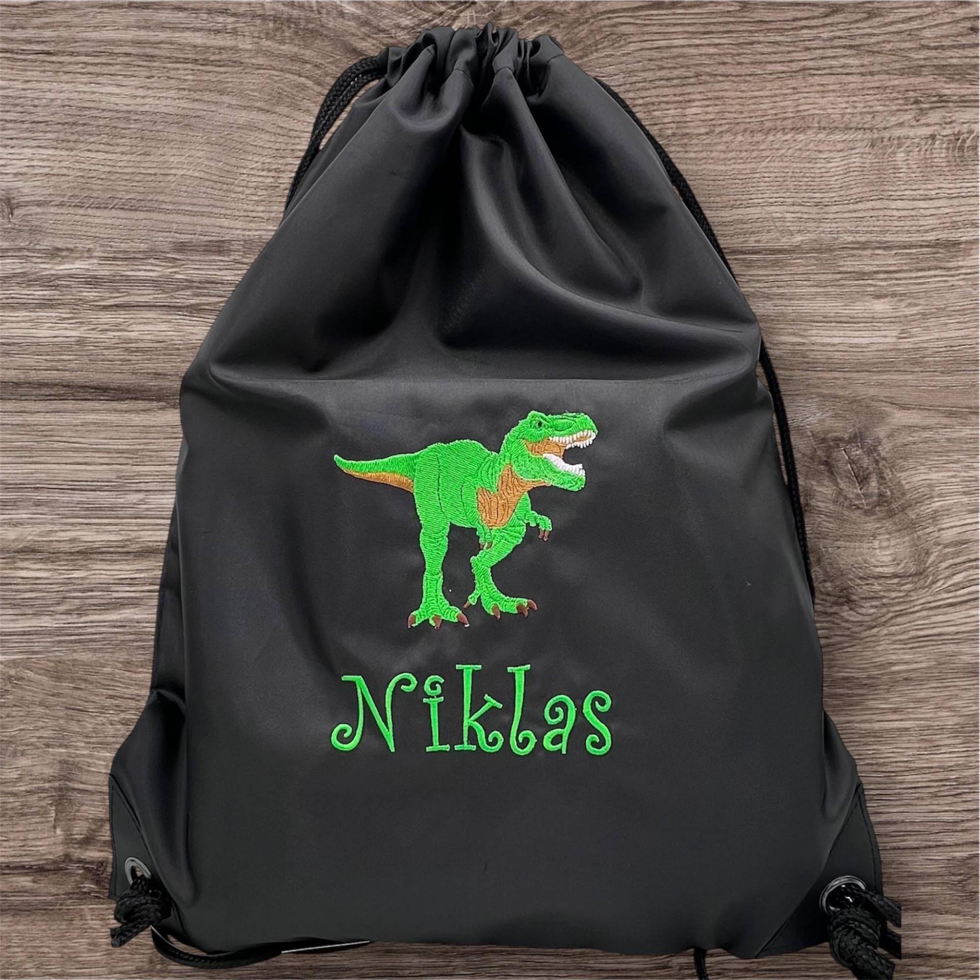 Turnbeutel Mit Stickmotiv Dinosaurier T-Rex | #12 + Namen/Für Kindergarten, Krippe Oder Schule Wäschebeutel Wechselkleidung Turnbeutel Mit Stickmotiv Dinosaurier T-Rex | #12 + Namen/Für Kindergarten, Krippe Oder Schule Wäschebeutel Wechselkleidung von KimKalvin