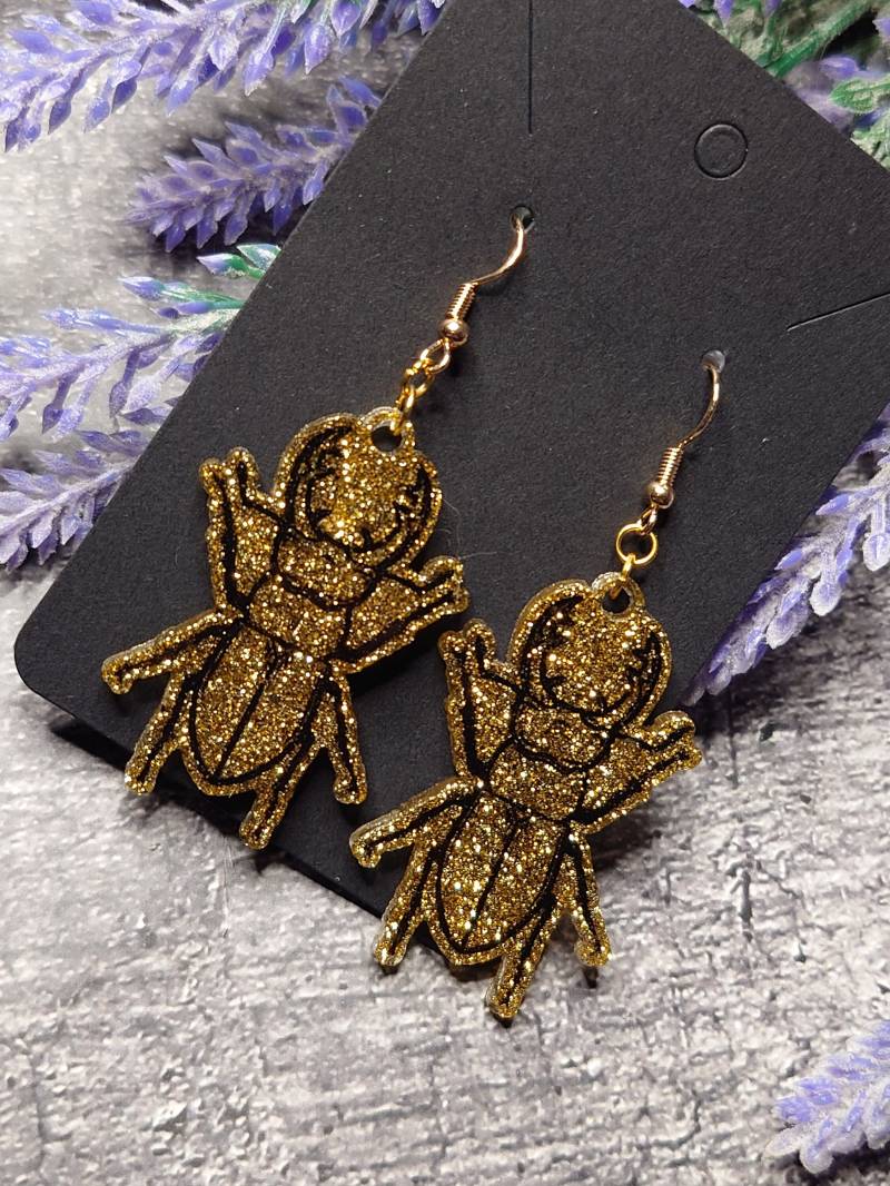 Golden Glitzernde Hirschkäfer Ohrringe Mit Schwarzen Outlines von KokoCrafting