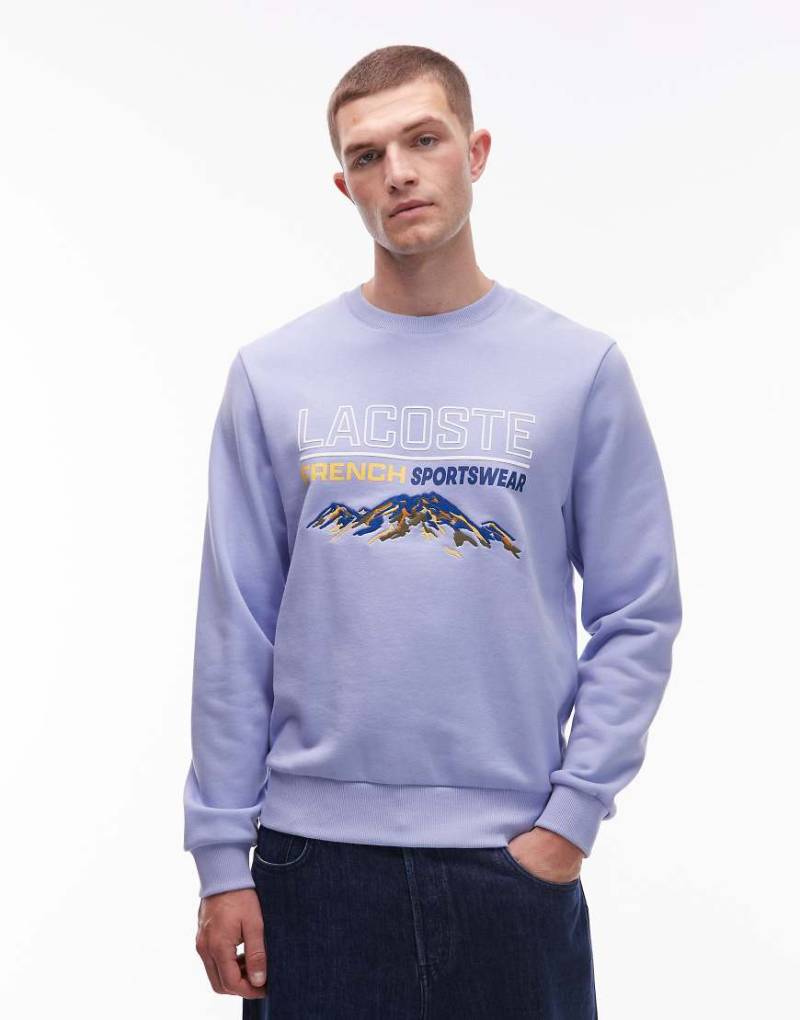 Lacoste - Sweatshirt in Flieder mit Grafik-Blau von Lacoste
