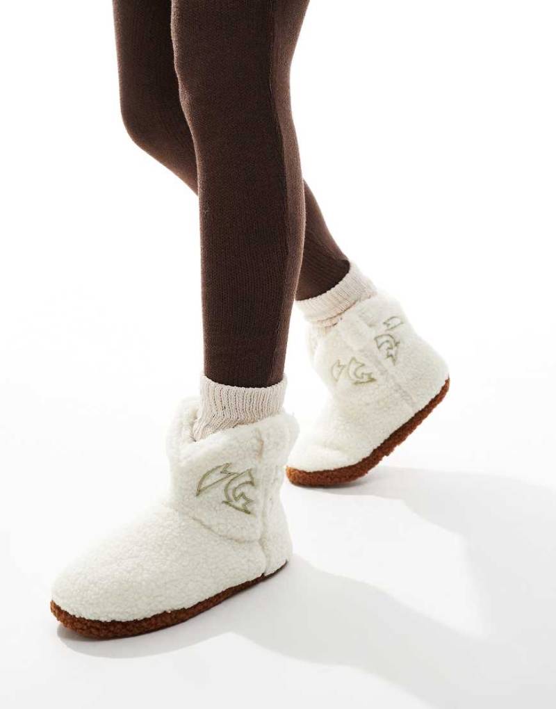 Loungeable - Hausschuh-Stiefel im Cowboy-Design aus Teddyfell in Cremeweiß Loungeable - Hausschuh-Stiefel im Cowboy-Design aus Teddyfell in Cremeweiß von Loungeable