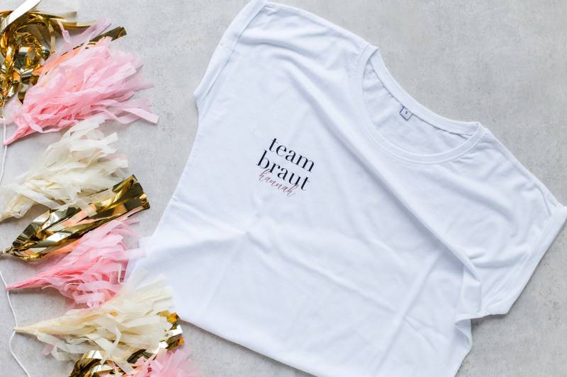 T-Shirt "Team Braut + Name" Weiß Loose Fit - Schriftzug in Verschiedenen Farben von MalinskyDesign