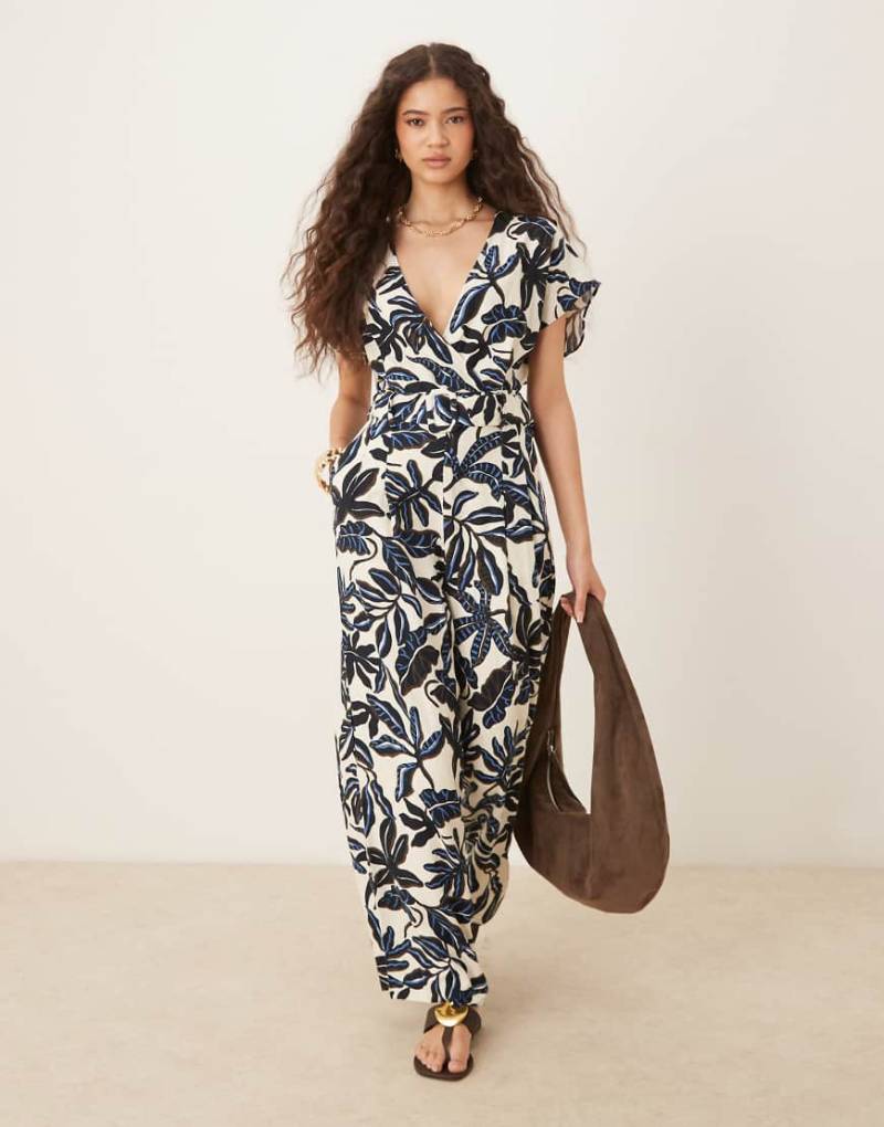 Mango - Jumpsuit in Blau mit Blumenmuster, V-Ausschnitt und Gürtel von Mango