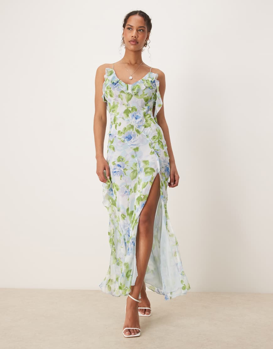 Mango - Kleid in Blassblau mit V-Ausschnitt, Rüschen, Seitenschlitz und botanischem Muster Mango - Kleid in Blassblau mit V-Ausschnitt, Rüschen, Seitenschlitz und botanischem Muster von Mango