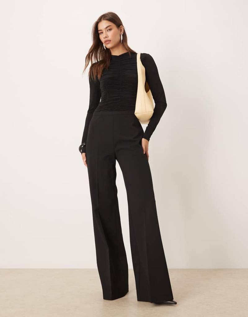 Mango - Langärmliger, strukturierter Jumpsuit in Schwarz Mango - Langärmliger, strukturierter Jumpsuit in Schwarz von Mango