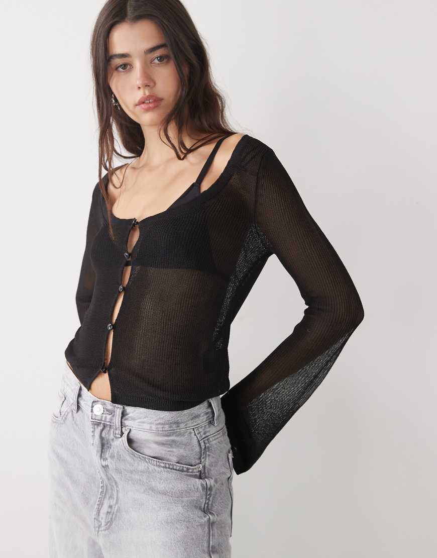 Monki - Slim Fit Strickjacke in transparentem Schwarz mit Knopfleiste Monki - Slim Fit Strickjacke in transparentem Schwarz mit Knopfleiste von Monki
