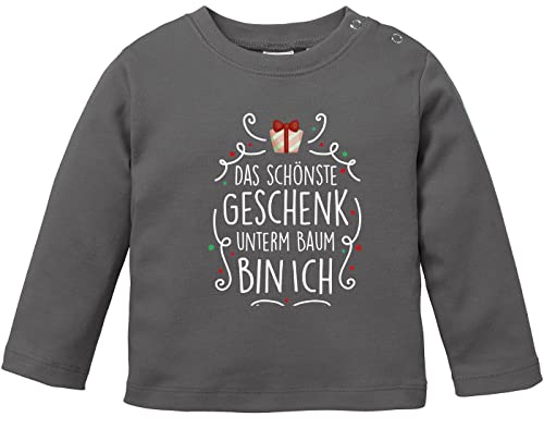 MoonWorks® Baby Langarmshirt mit Spruch Weihnachten Das schönste Geschenk unterm Baum Bin ich Babyshirt Jungen Mädchen dunkelgrau 92/98 (16-24-Monate) von MoonWorks