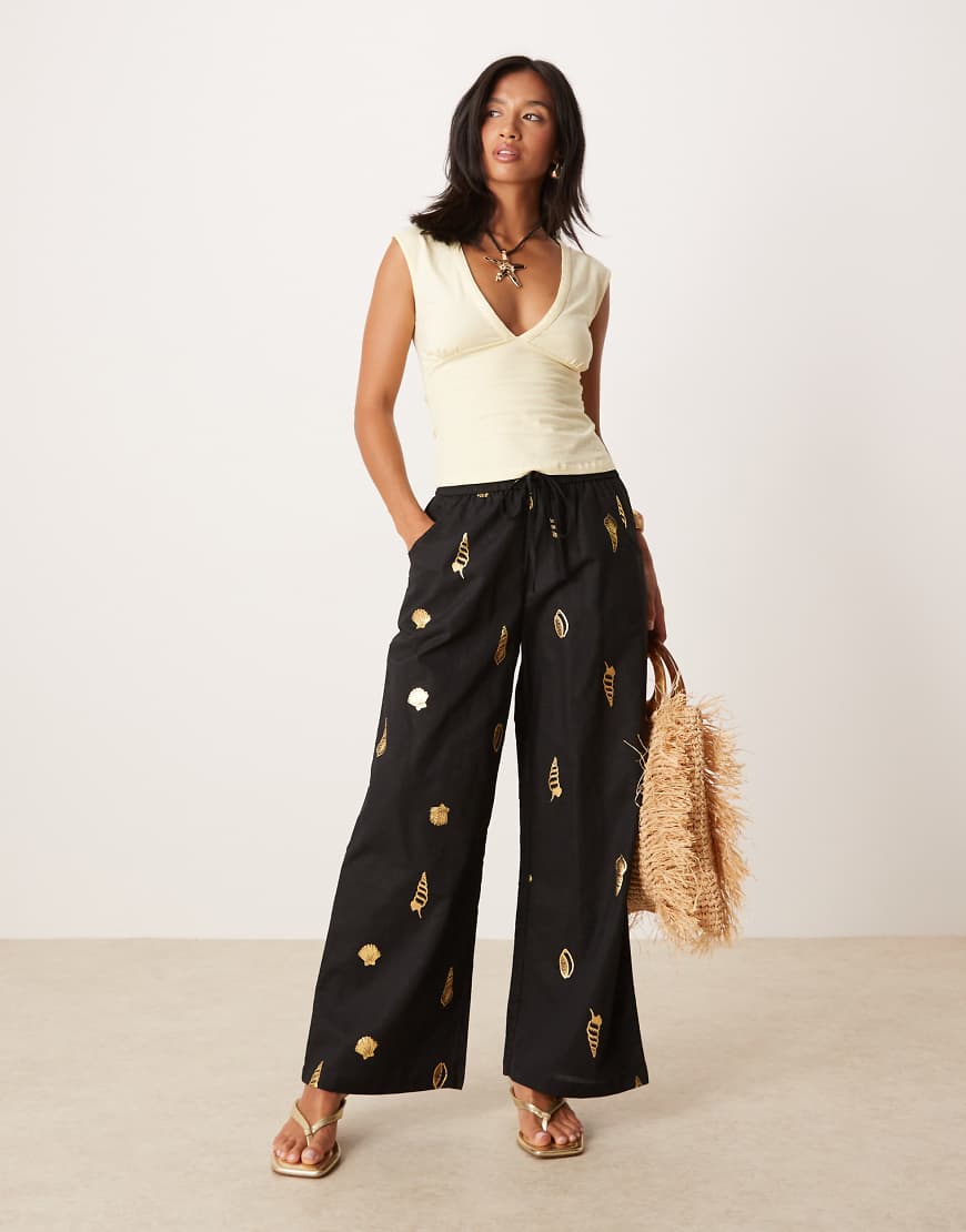 Never Fully Dressed Petite - Hose in Schwarz mit weitem Bein und goldfarbenem Muschelmuster von Never Fully Dressed