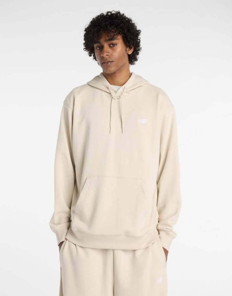 New Balance - Sport Essentials - Kapuzenpullover aus French Terry in Timberwolf-Grau New Balance - Sport Essentials - Kapuzenpullover aus French Terry in Timberwolf-Grau von New Balance