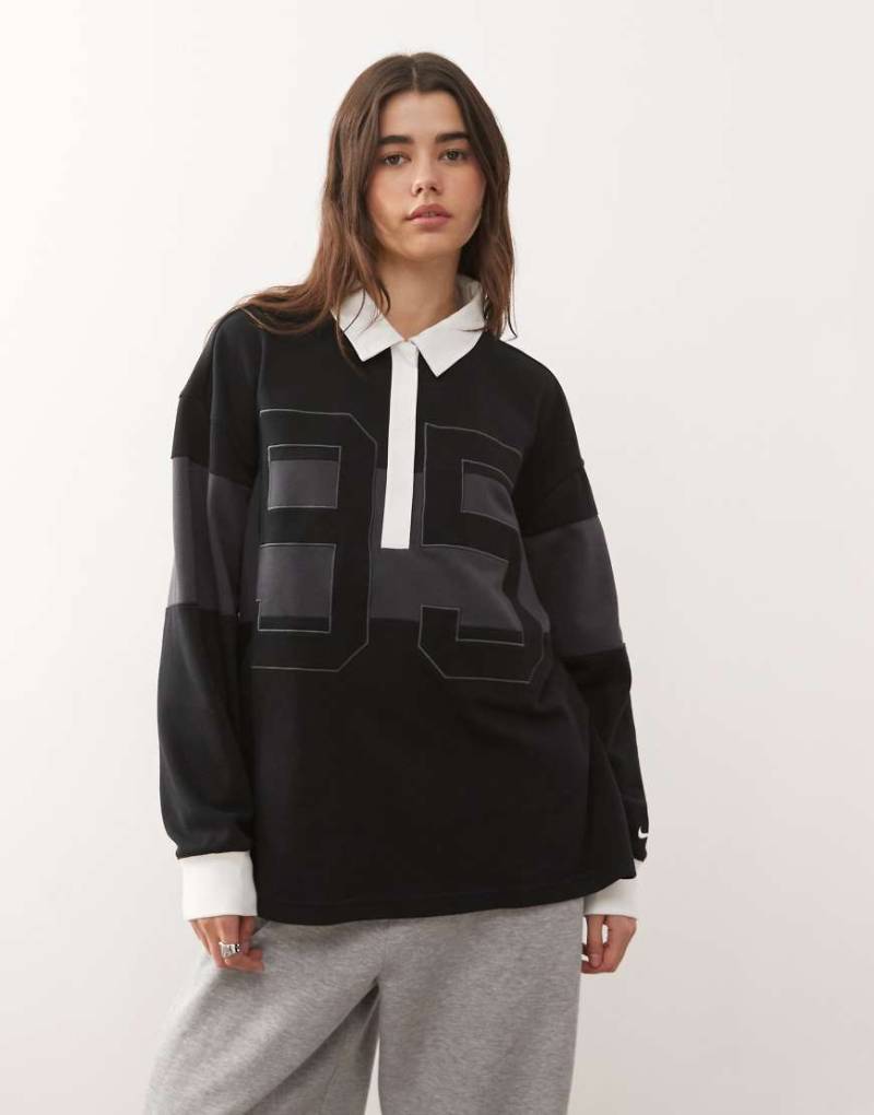 Nike - Street - Langärmliges Polohemd in Grau und Schwarz mit Grafik von Nike