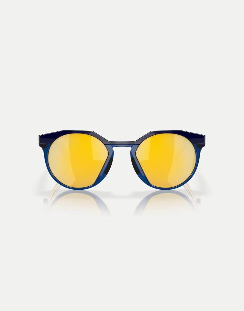 Oakley - Kylian Mbappé Signature Series HSTN - Runde, polarisierte Sonnenbrille in Marineblau/transparentem Blau mit goldfarbenen verspiegelten Gläsern von Oakley