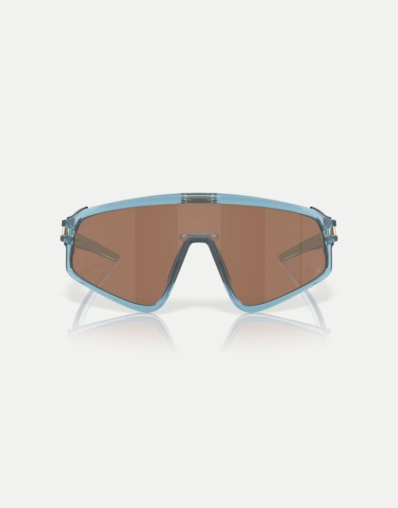 Oakley - Kylian Mbappé Signature Series Latch - Shield-Sonnenbrille in transparentem Stonewash mit verspiegelten braunen Gläsern und Paneel-Detail von Oakley