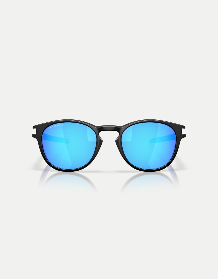 Oakley - Latch Fathom Collection - Runde Sonnenbrille in Mattschwarz mit blau verspiegelten Gläsern Oakley - Latch Fathom Collection - Runde Sonnenbrille in Mattschwarz mit blau verspiegelten Gläsern von Oakley